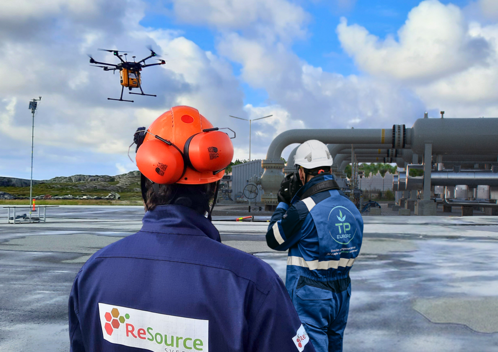 A TP Europe technician at an industrial plant, a drone overhead