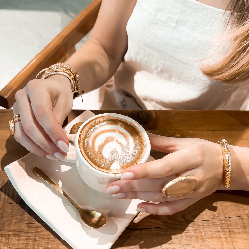 Latte art, gold rings and bracelets in one shot